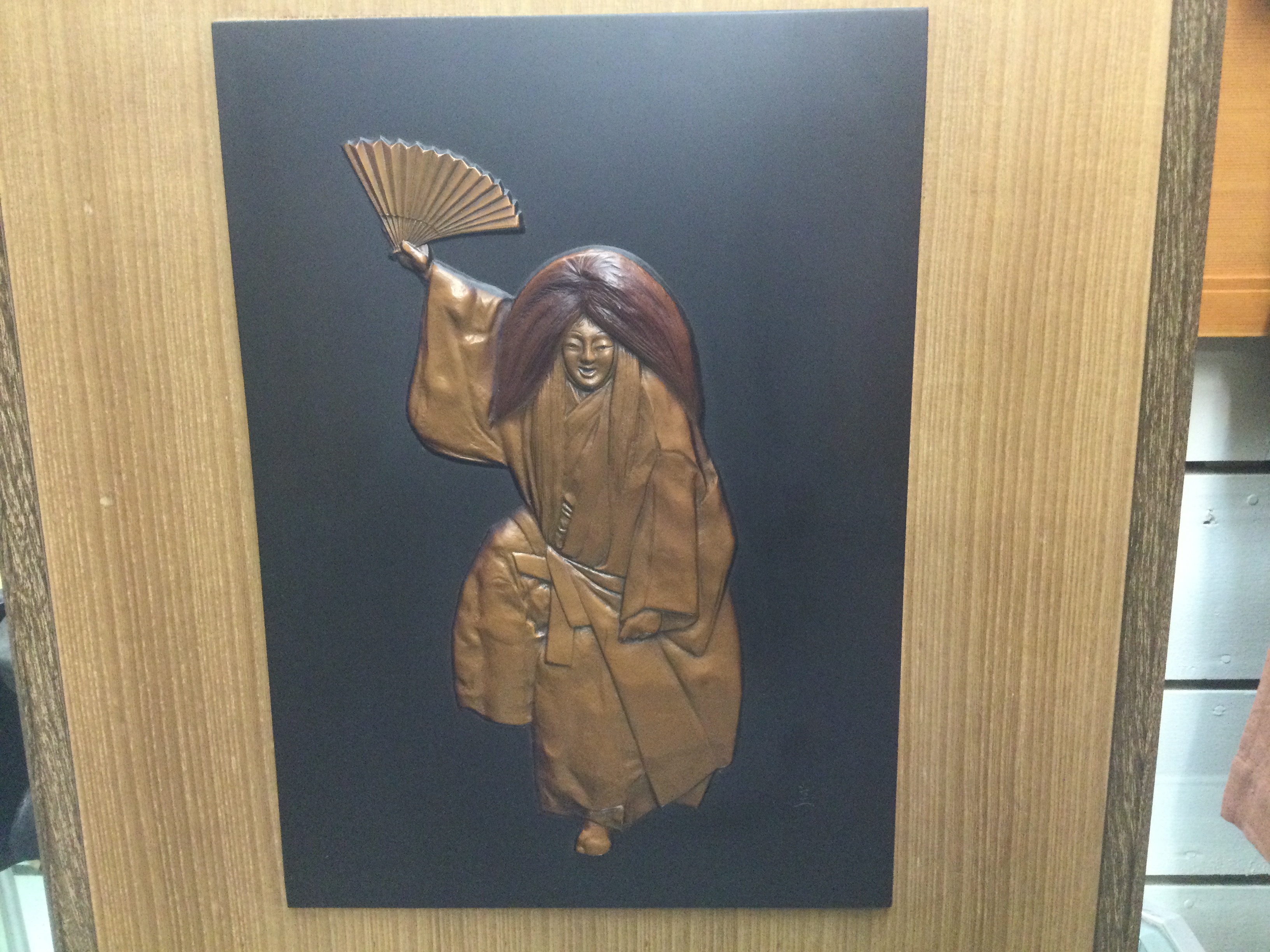 Mounted bronze plaque of dancer